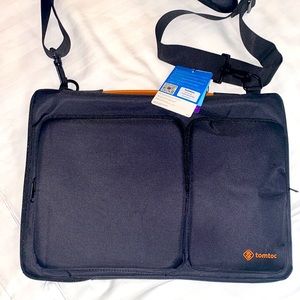 Tomtoc 14-15” MacBook Pro case with carry handle and shoulder belt.